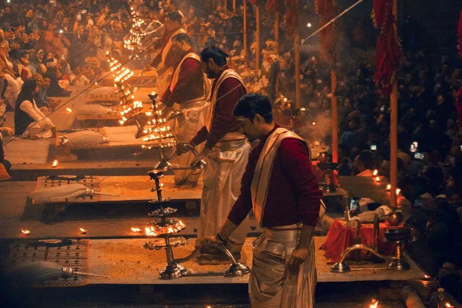 Priests performing the traditional Ganga Aarti ceremony on the ghats of Varanasi with glowing lamps and spiritual atmosphere